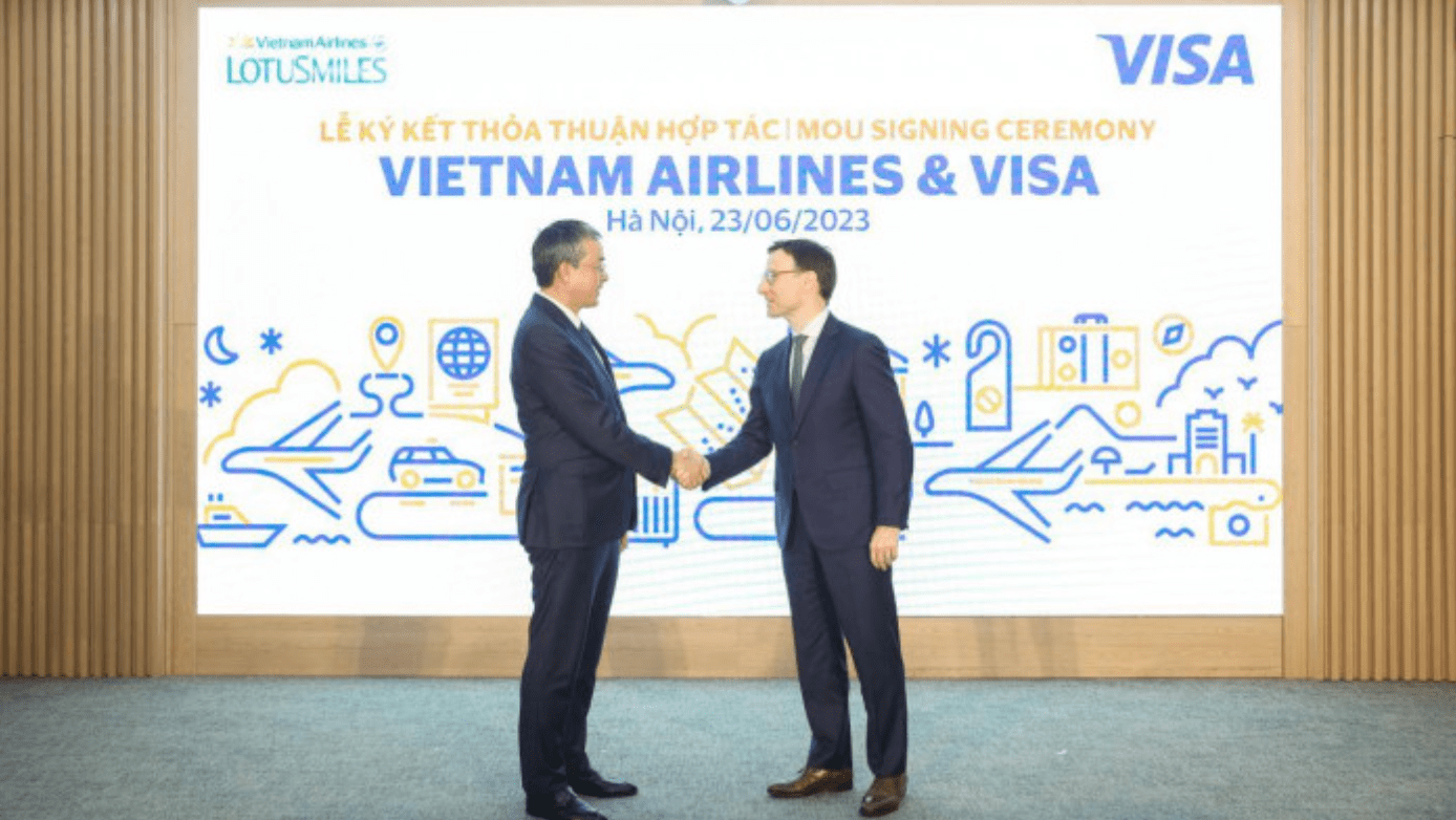 Ông Đặng Ngọc Hoà, Chủ tịch HĐQT Vietnam Airlines (bên trái) bắt tay ông Oliver Jenkyn, Chủ tịch Thị trường Toàn cầu của Visa sau khi chứng kiến lễ ký